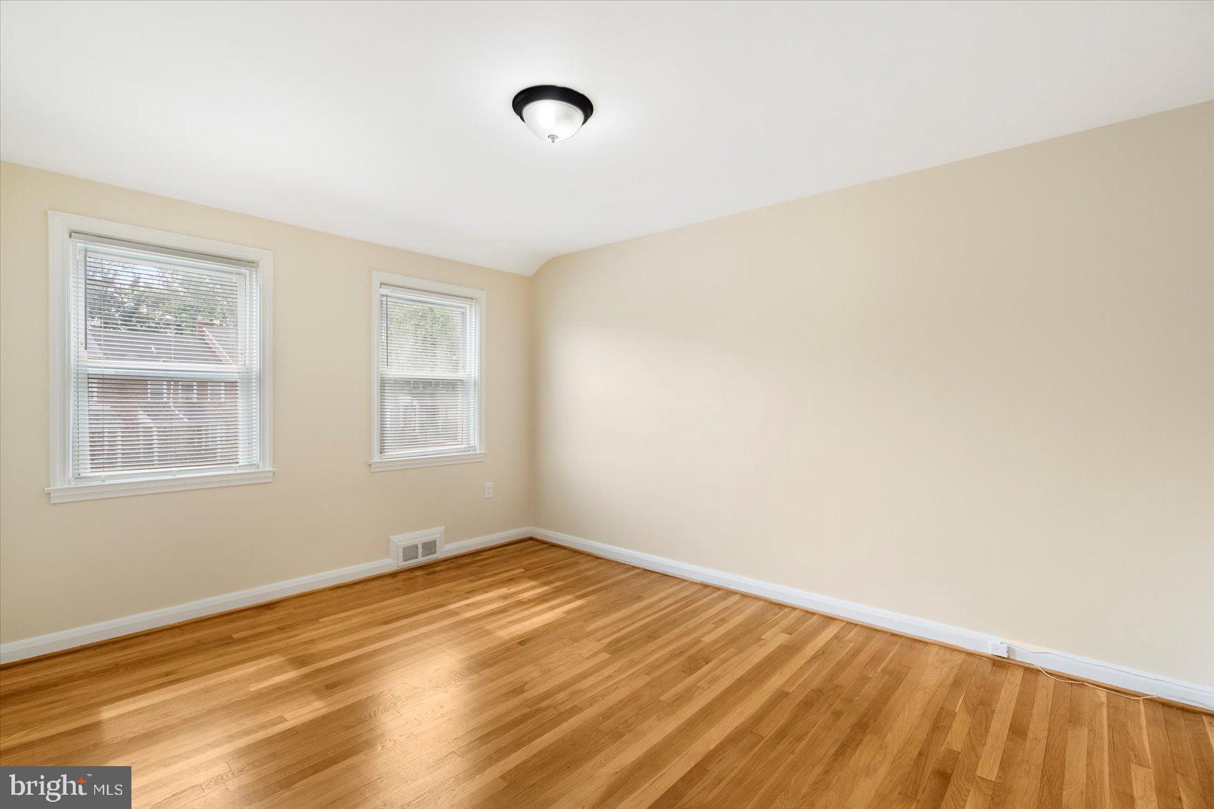 1444 Meridene Drive Baltimore, MD 21239 - Photo 25 of 36 a view of empty room with wooden floor and fan