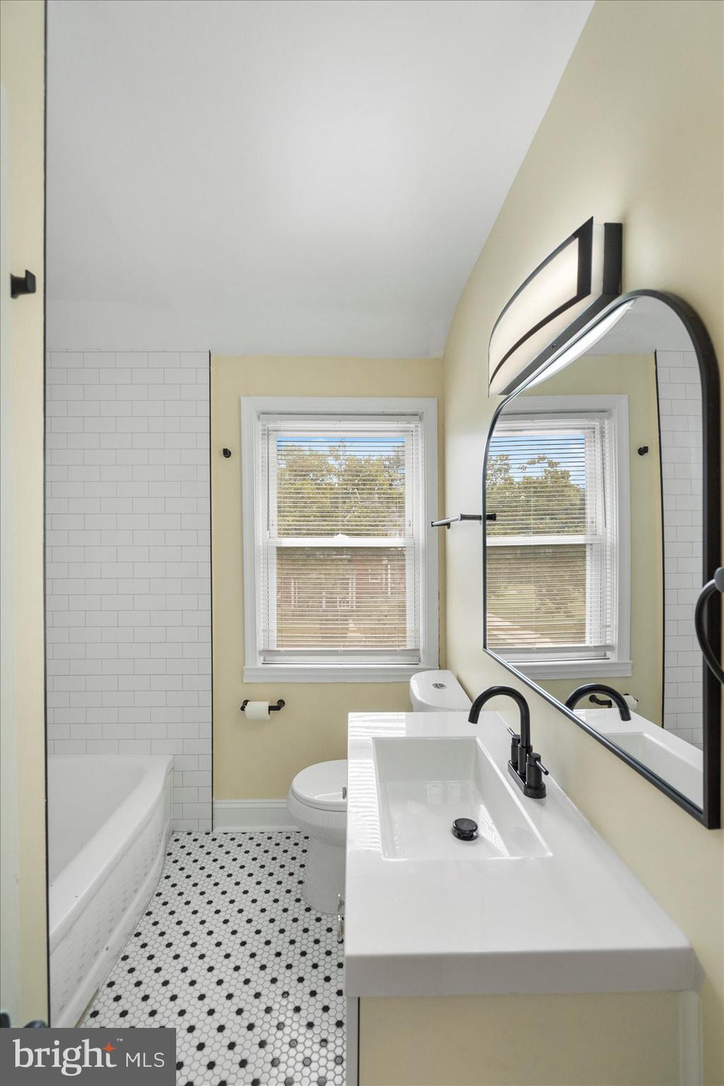 1444 Meridene Drive Baltimore, MD 21239 - Photo 29 of 36 a bathroom with a sink a bathtub and next to a window