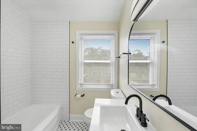 a bathroom with a sink a bathtub and a shower
