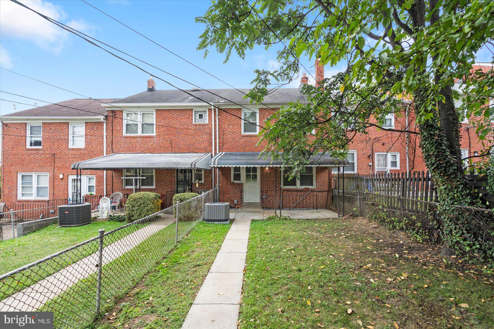 1444 Meridene Drive Baltimore, MD 21239 - Photo 36 of 36 a front view of a house with a yard
