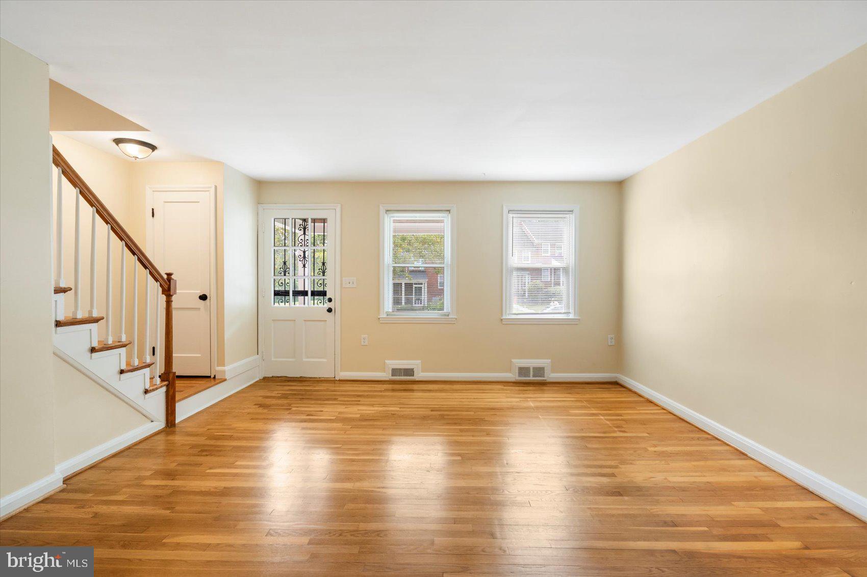 1444 Meridene Drive Baltimore, MD 21239 - Photo 7 of 36 a view of empty room with wooden floor and fan