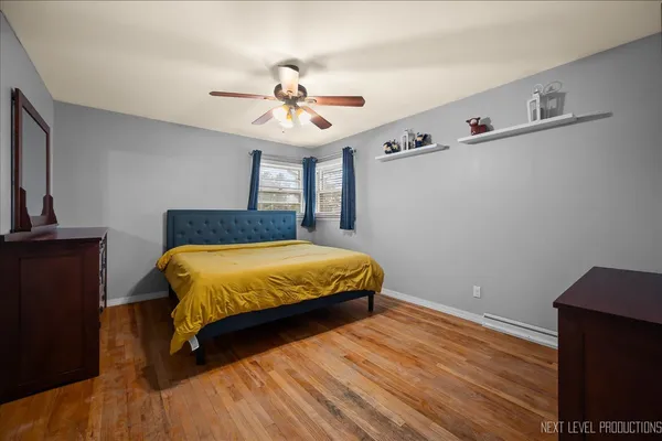 a spacious bedroom with a bed and a chandelier