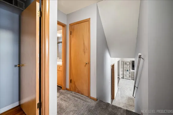 a view of a hallway with wooden floor and entryway