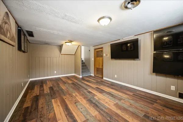 a view of empty room with projector and screen