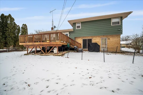 a view of a house with snow on the road
