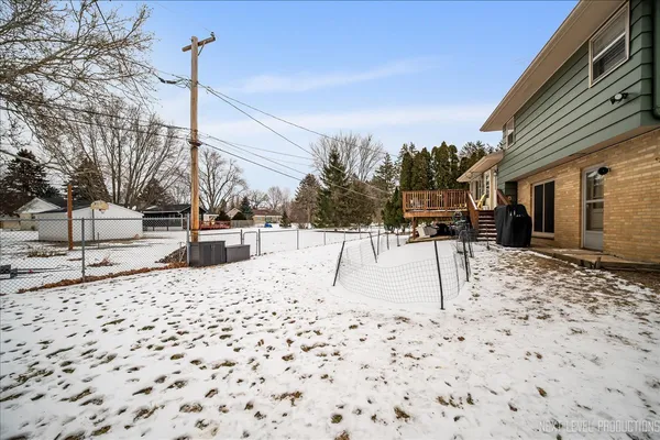 a view of a backyard of snow on the road