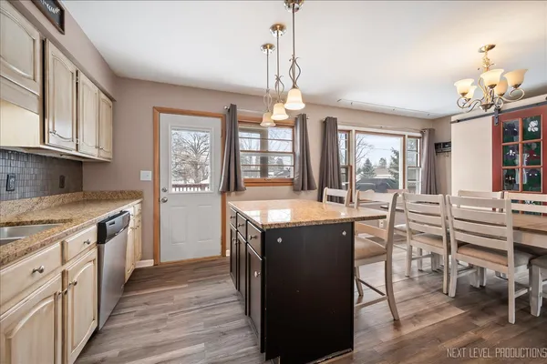 a kitchen with wooden cabinets and center island