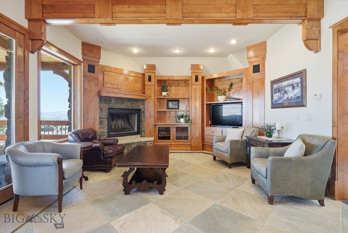1240 Twin River Cutoff Road Manhattan, MT 59741 - Photo 17 of 88 Warm living room with custom built-ins and stone fireplace