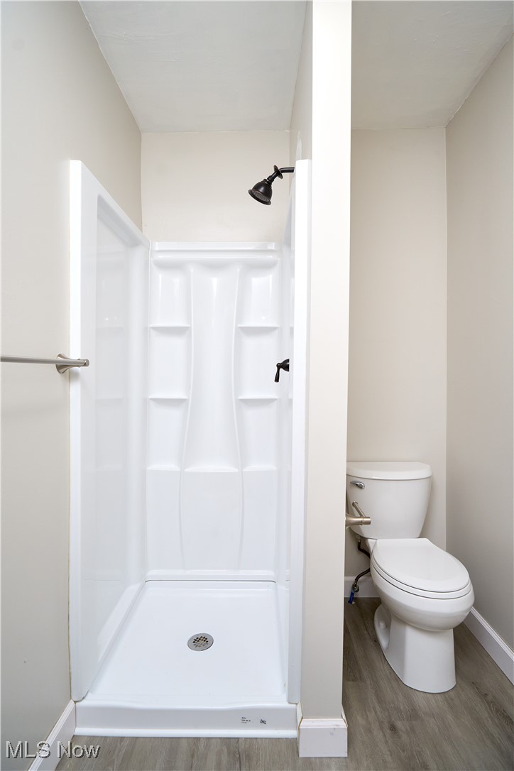 5432 State Road Parma, OH 44134 - Photo 33 of 47 Bathroom featuring a stall shower and light wood-style flooring