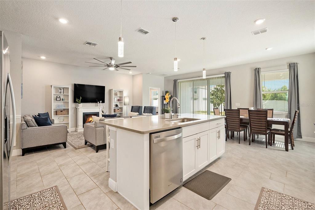 10903 Honor Road Tampa, FL 33625 - Photo 12 of 36 a large white kitchen with stainless steel appliances granite countertop a stove and a sink