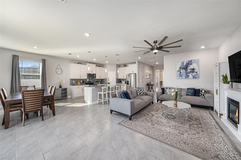 10903 Honor Road Tampa, FL 33625 - Photo 17 of 36 a living room with furniture kitchen view and a flat screen tv