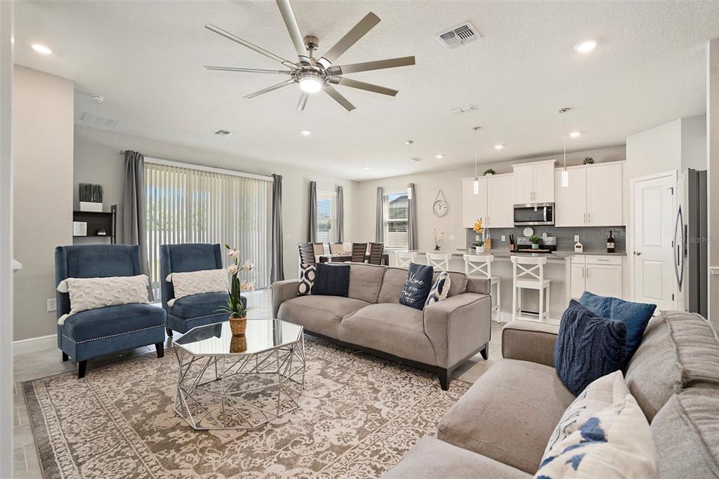 10903 Honor Road Tampa, FL 33625 - Photo 18 of 36 a living room with furniture kitchen view and a chandelier