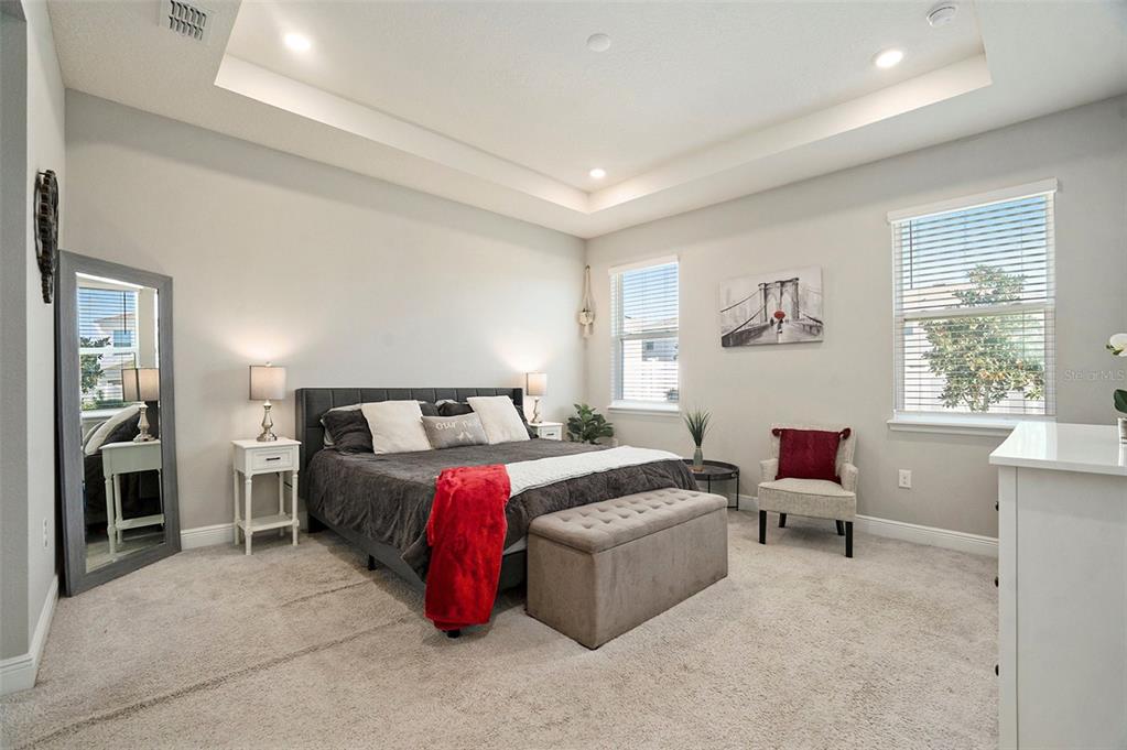 10903 Honor Road Tampa, FL 33625 - Photo 20 of 36 a spacious bedroom with a bed table chair and a window