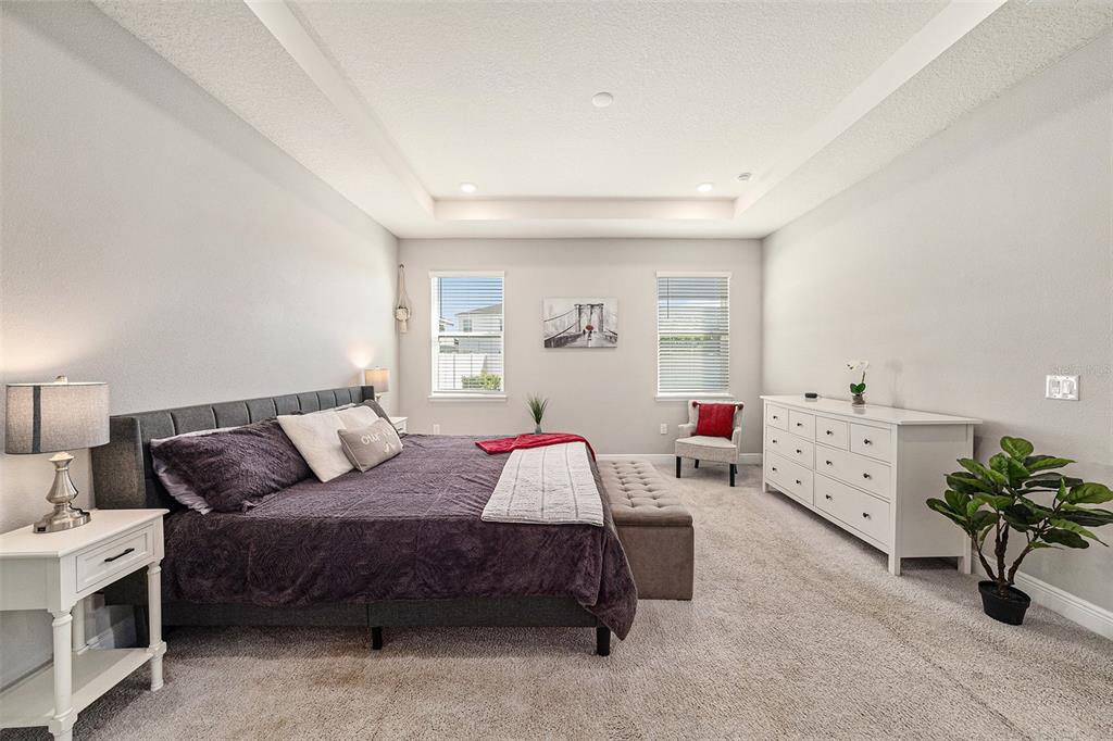 10903 Honor Road Tampa, FL 33625 - Photo 22 of 36 a spacious bedroom with a bed and a couch