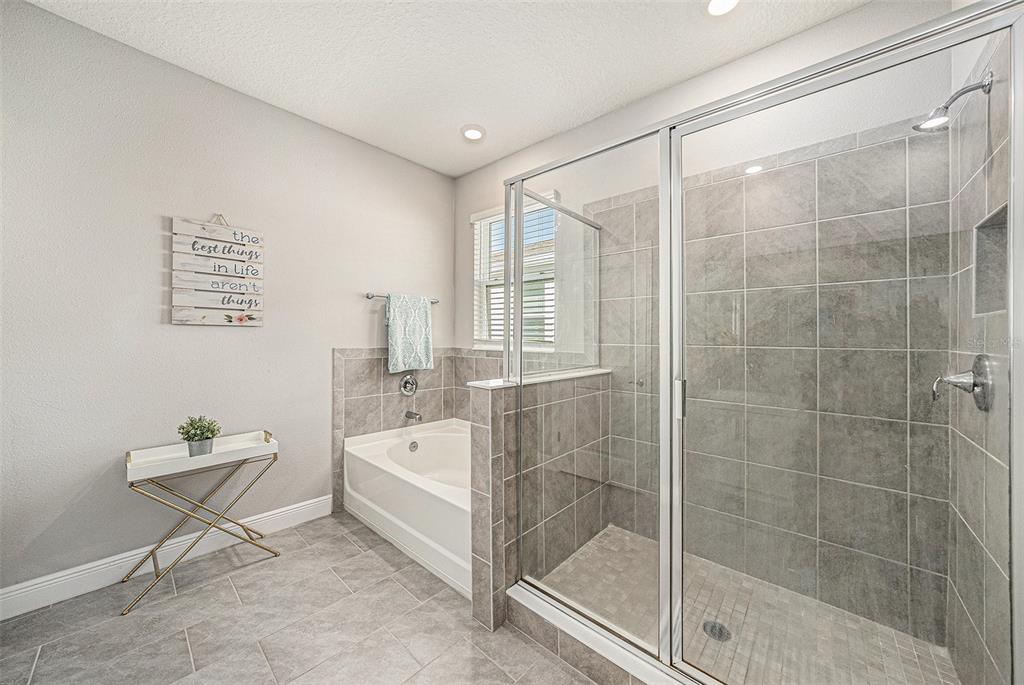 10903 Honor Road Tampa, FL 33625 - Photo 24 of 36 a bathroom with a bathtub and a shower