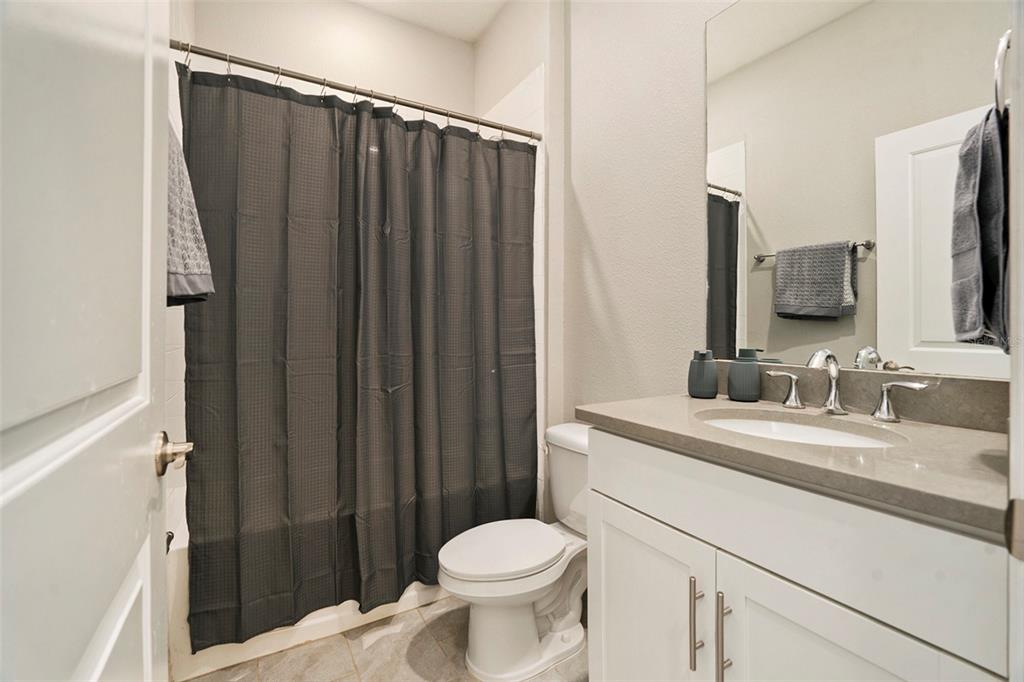 10903 Honor Road Tampa, FL 33625 - Photo 7 of 36 a bathroom with a granite countertop sink toilet and shower