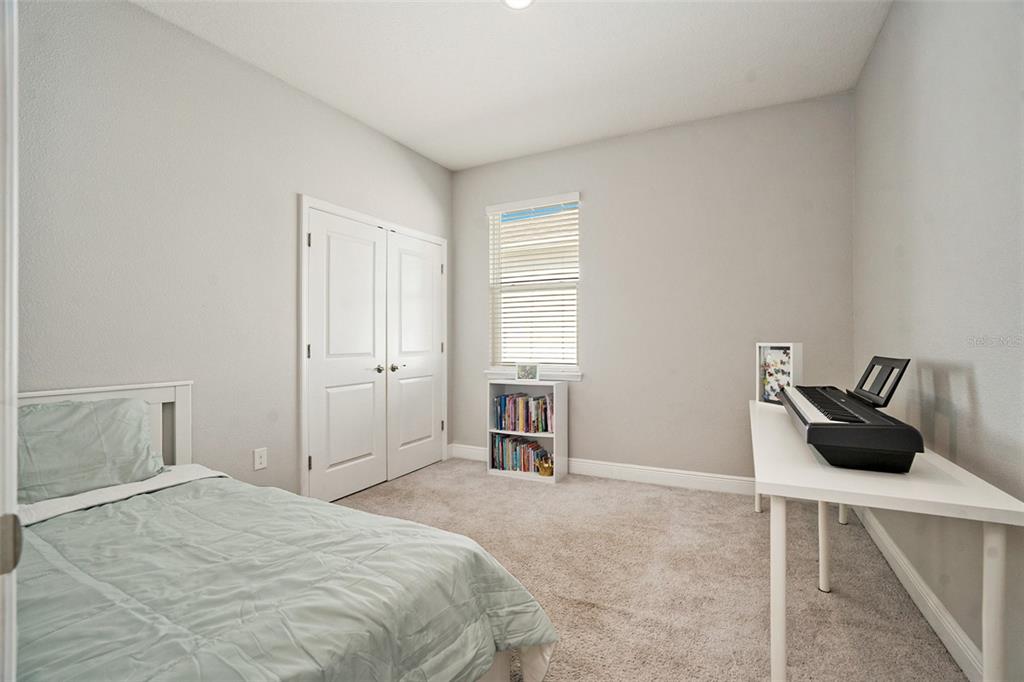 10903 Honor Road Tampa, FL 33625 - Photo 10 of 36 a bedroom with a bed and cabinets