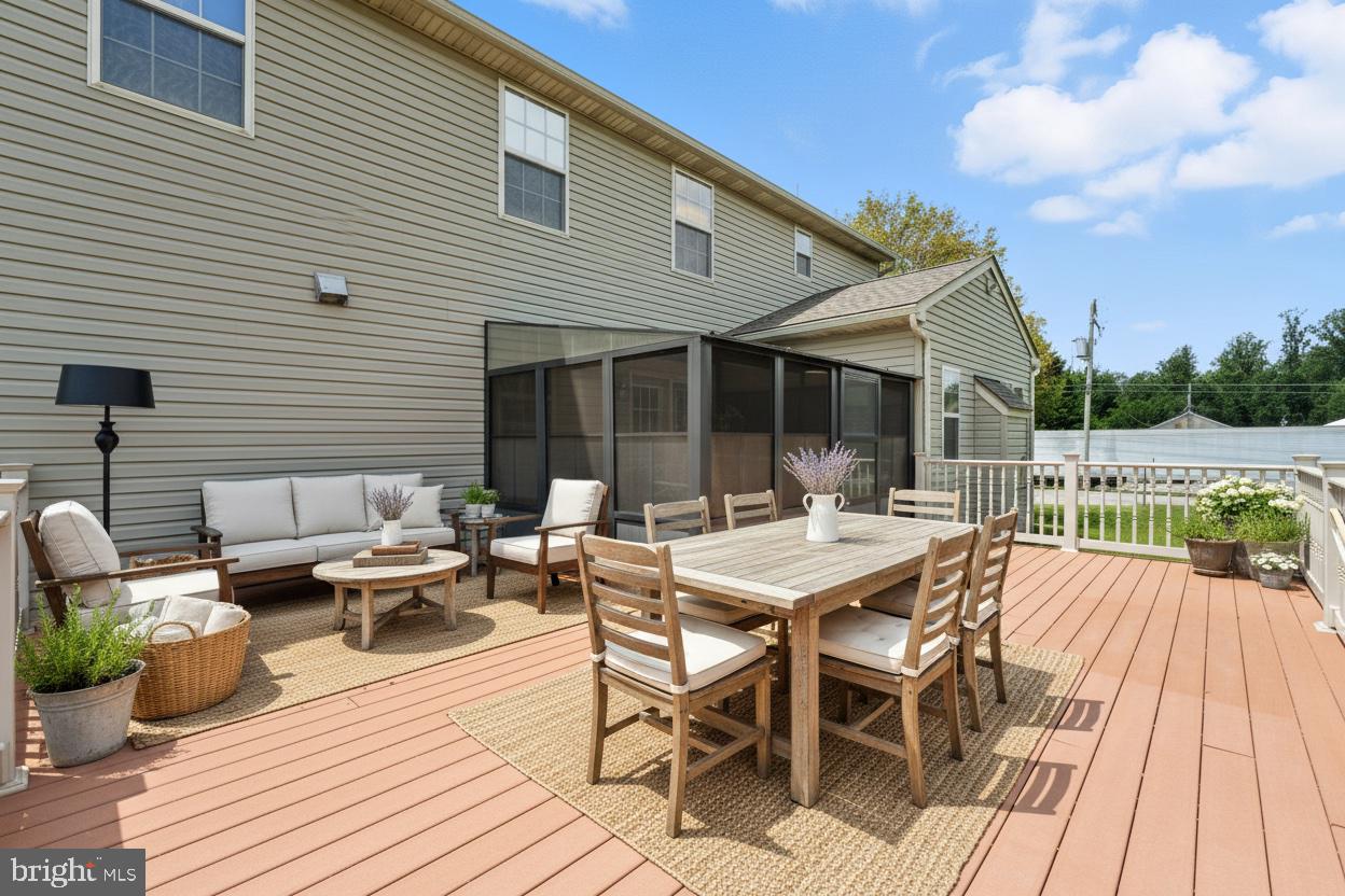 2 Radence Lane West Grove, PA 19390 - Photo 2 of 24 a view of a patio with dining table and chairs with wooden floor