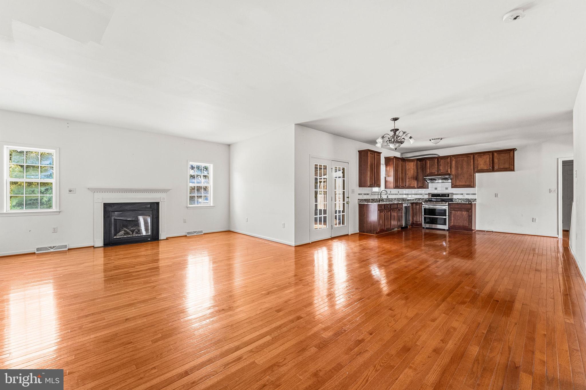 2 Radence Lane West Grove, PA 19390 - Photo 5 of 24 a view of empty room with kitchen and fireplace