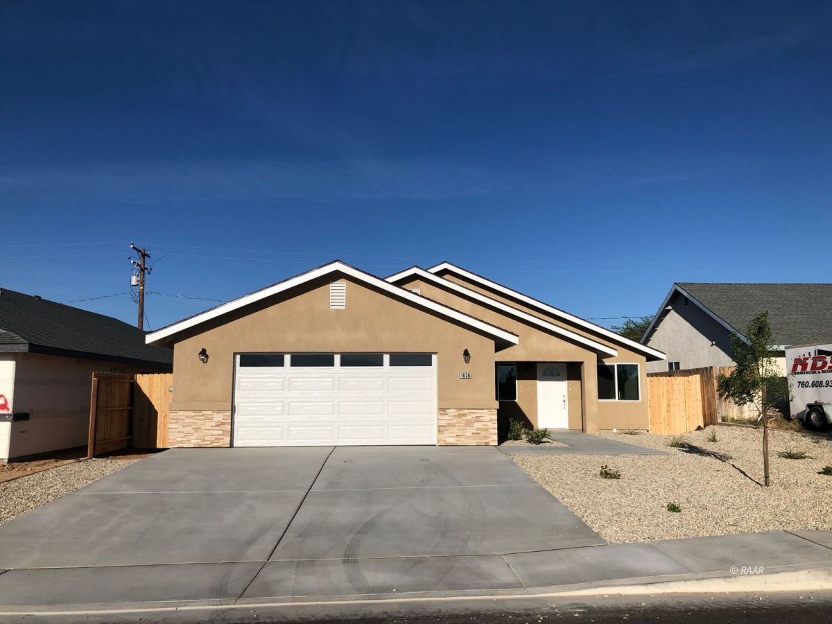 1636 South Mahan Street Ridgecrest, CA 93555 - Photo 1 of 1 a front view of a house with a yard and garage