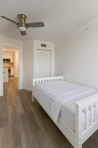 a bedroom with a bed and a chandelier