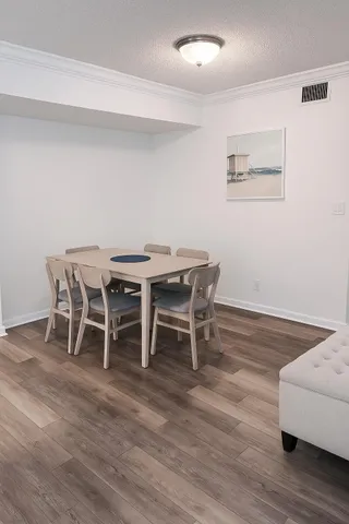 a dining room with furniture and wooden floor