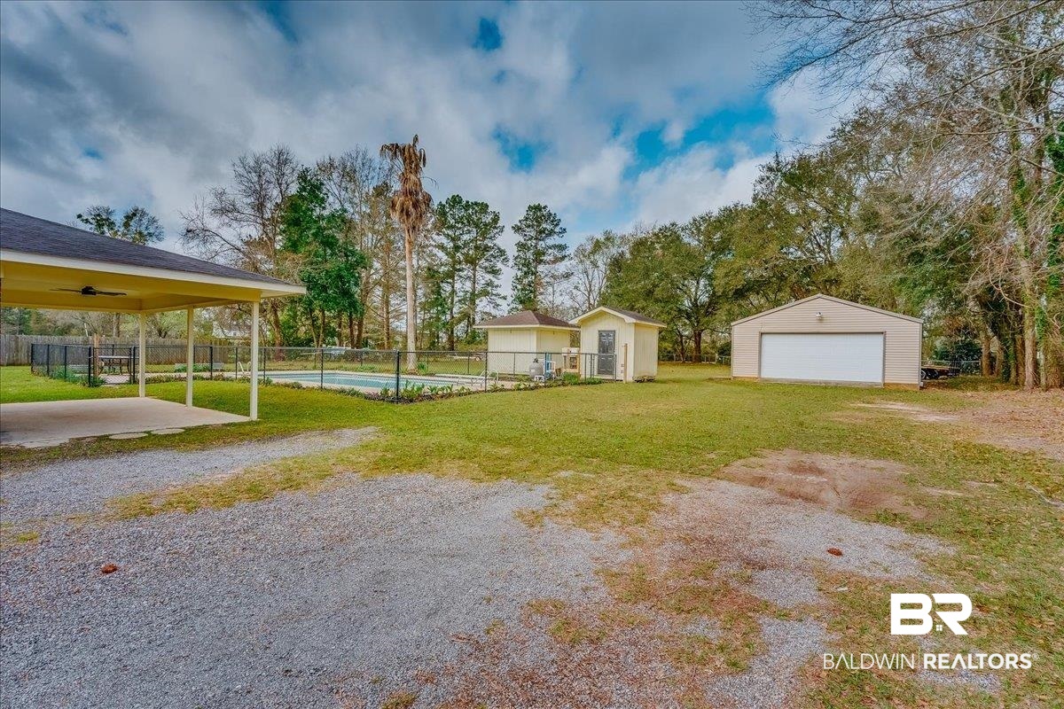 440 Dykes Road Mobile, AL 36608 - Photo 39 of 49 View of yard with a detached garage, an outbuilding, and fence