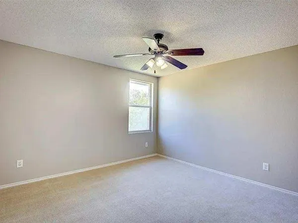 a view of room with window and ceiling fan