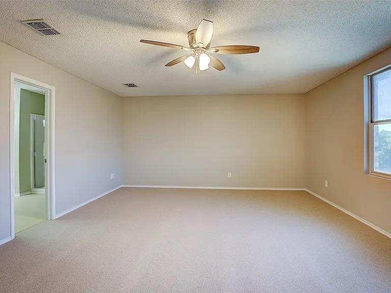 1033 Burnet Drive Mesquite, TX 75181 - Photo 15 of 21 an empty room with a window and a ceiling fan
