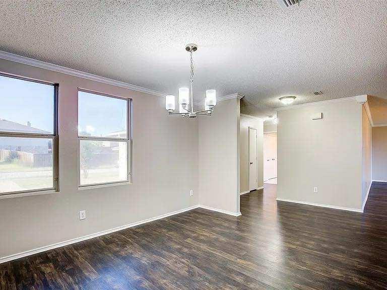 1033 Burnet Drive Mesquite, TX 75181 - Photo 7 of 21 a view of an empty room with wooden floor and a window