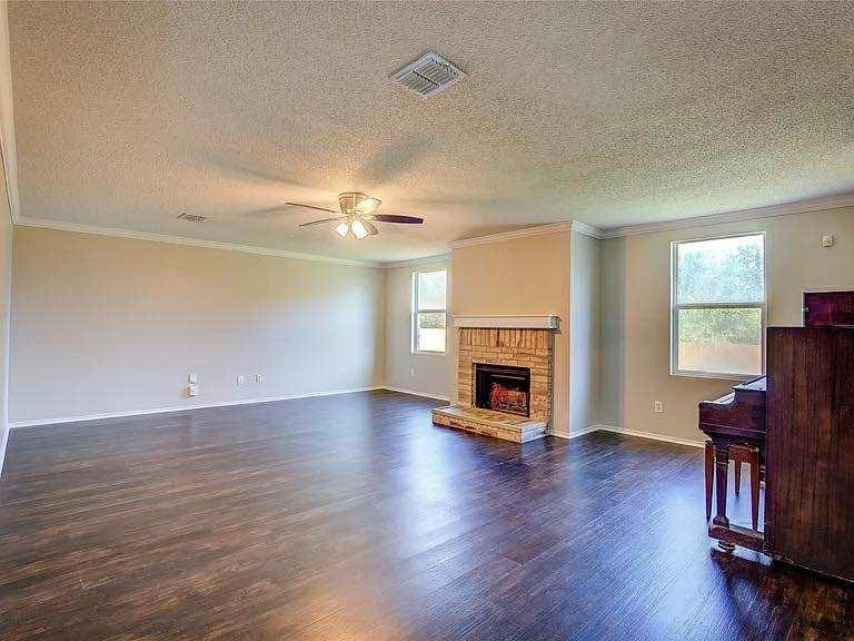 1033 Burnet Drive Mesquite, TX 75181 - Photo 8 of 21 an empty room with wooden floor fireplace and windows