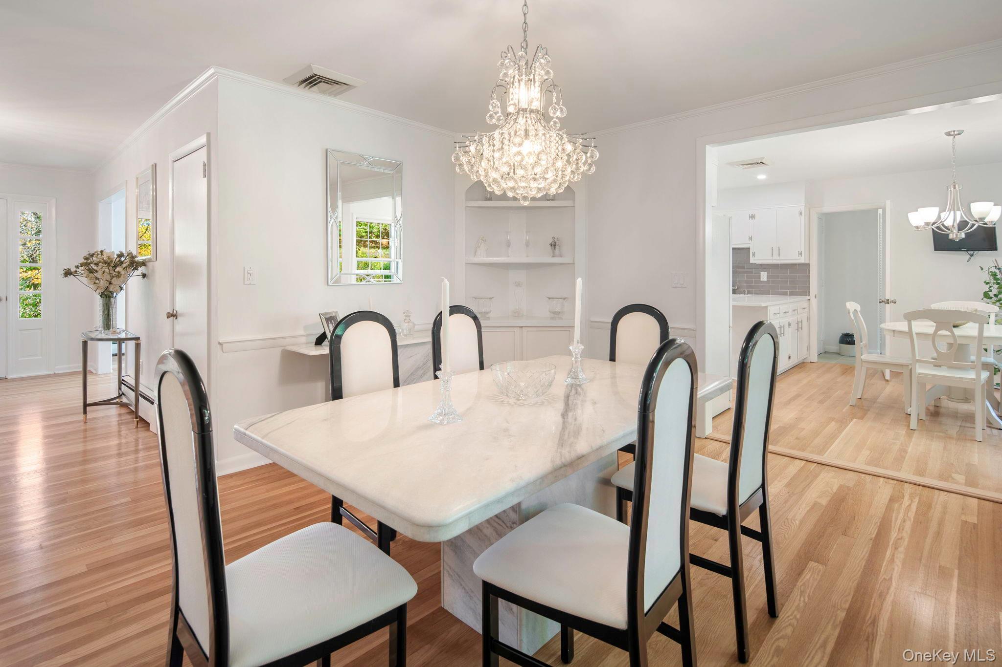 111 Seven Bridges Road Chappaqua, NY 10514 - Photo 14 of 29 a view of a dining room with furniture and chandelier