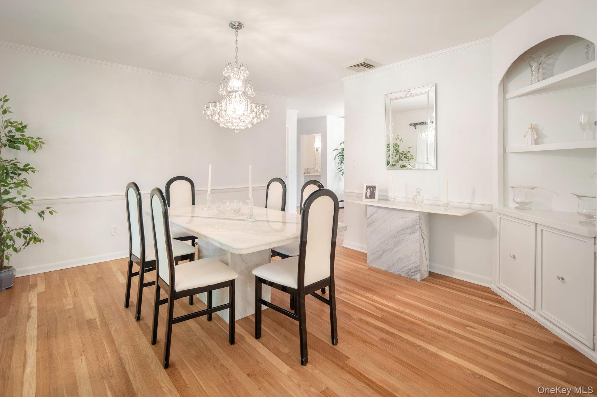 111 Seven Bridges Road Chappaqua, NY 10514 - Photo 15 of 29 a view of a dining room with furniture and wooden floor
