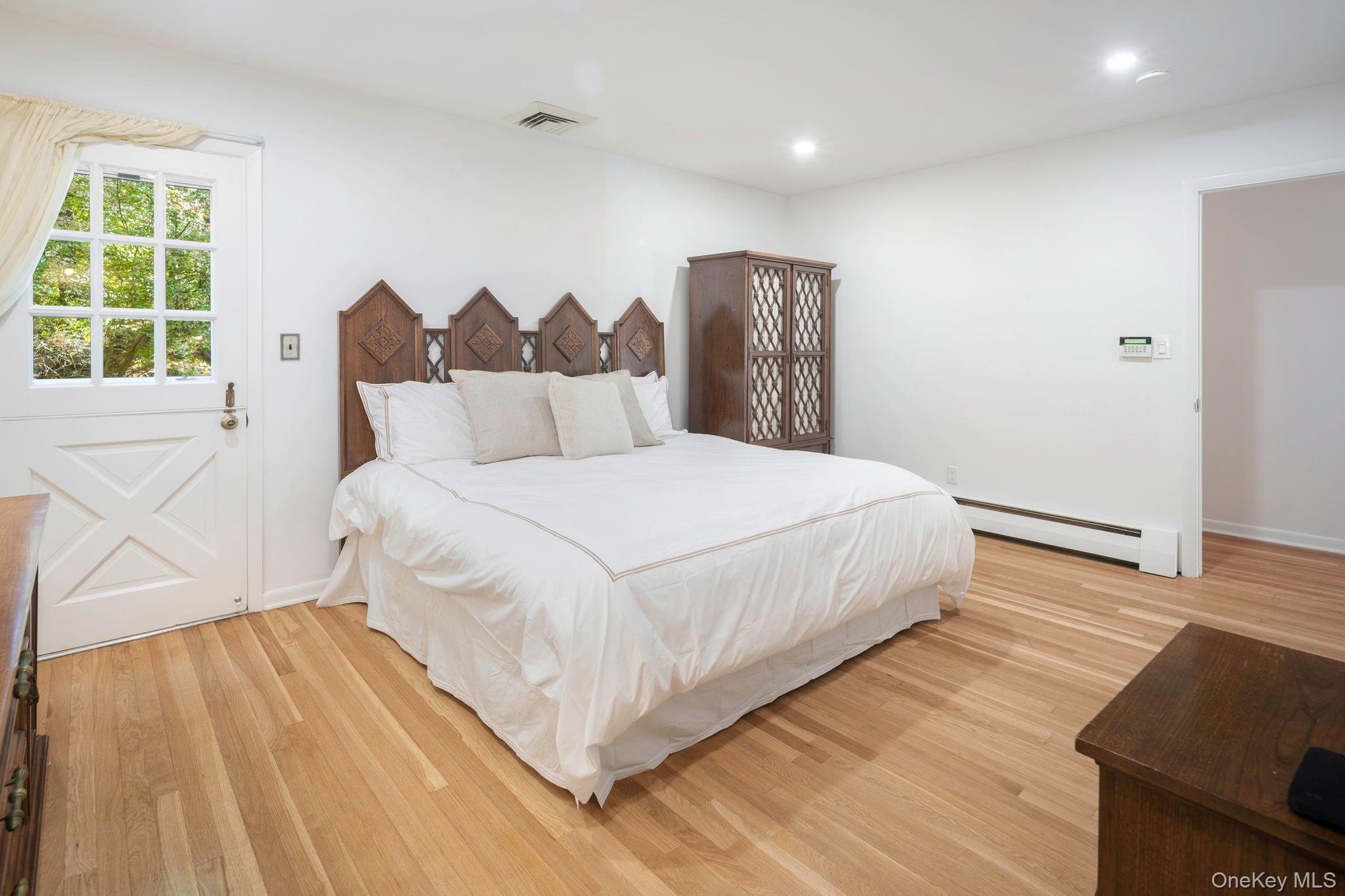 111 Seven Bridges Road Chappaqua, NY 10514 - Photo 21 of 29 a large bed sitting in a bedroom next to a window