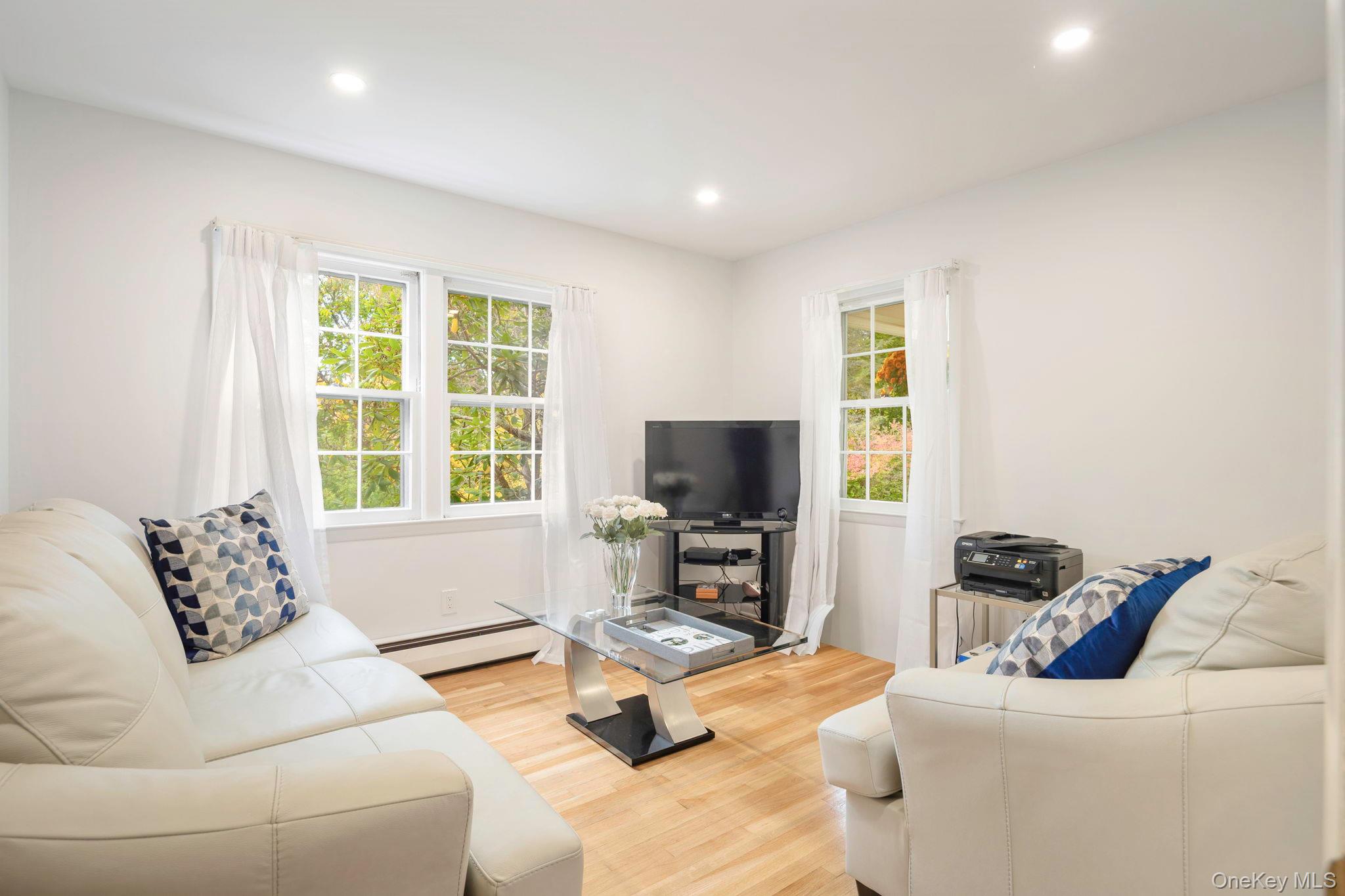 111 Seven Bridges Road Chappaqua, NY 10514 - Photo 25 of 29 a living room with furniture and a flat screen tv