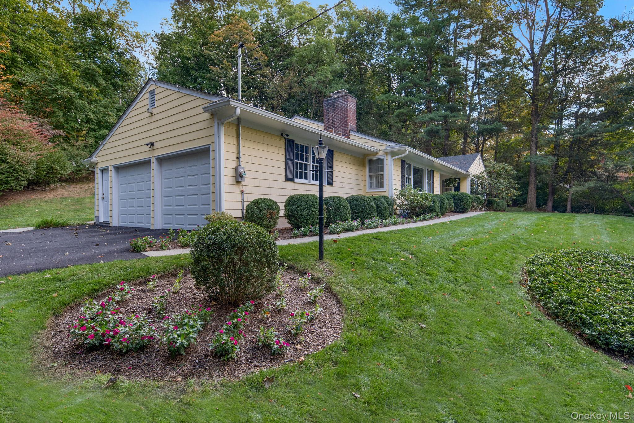 111 Seven Bridges Road Chappaqua, NY 10514 - Photo 4 of 29 a view of a house with a yard and a garden