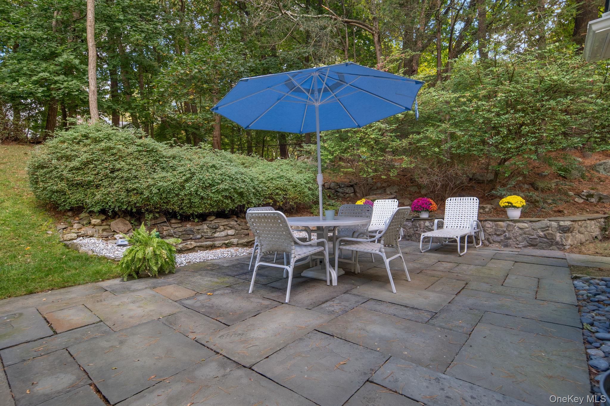 111 Seven Bridges Road Chappaqua, NY 10514 - Photo 6 of 29 a view of backyard with seating space and trees