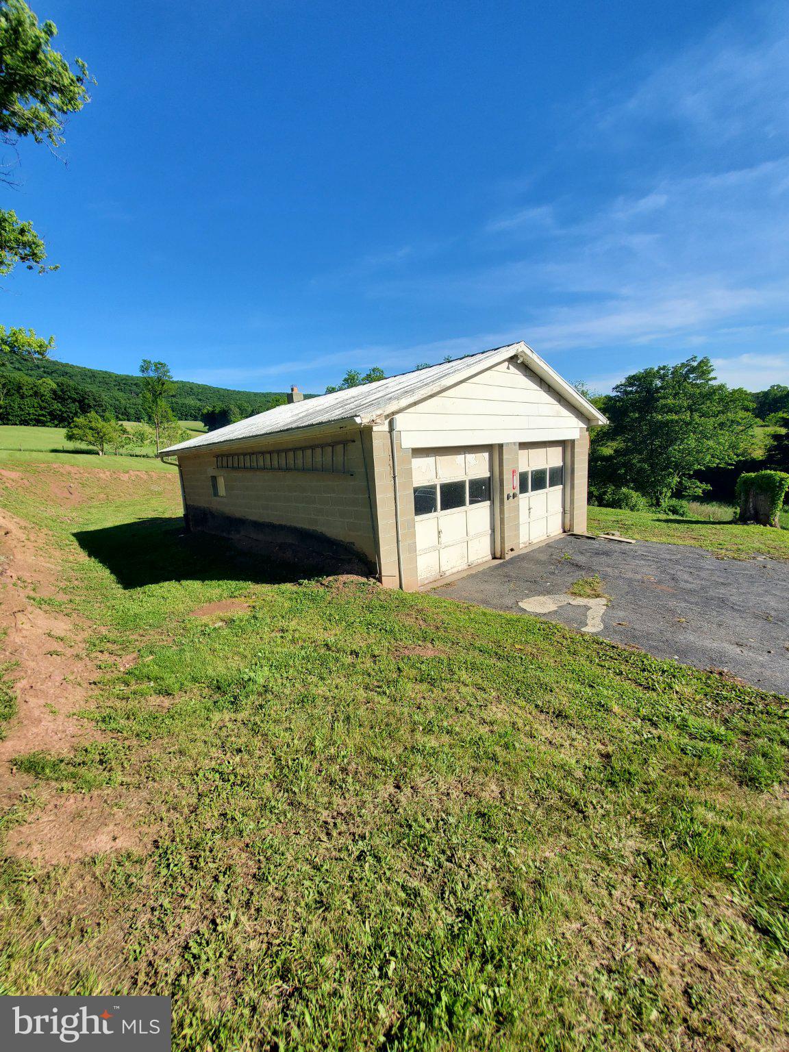 7881 Ford Hill Road Rio, WV 26755 - Photo 8 of 27 Charming garage amidst lush greenery.