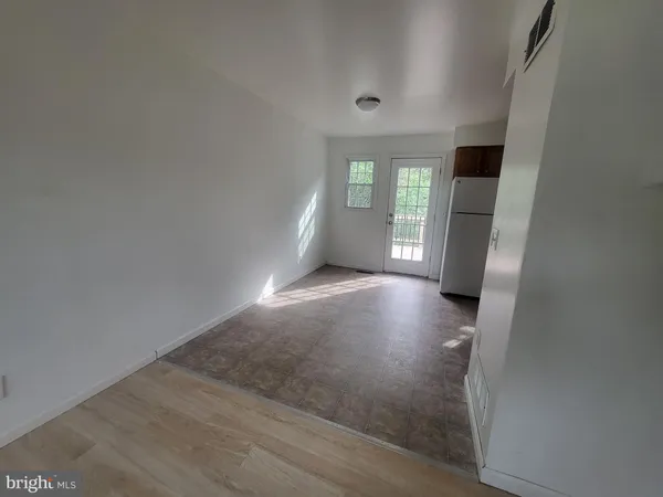 an empty room with windows and entrance