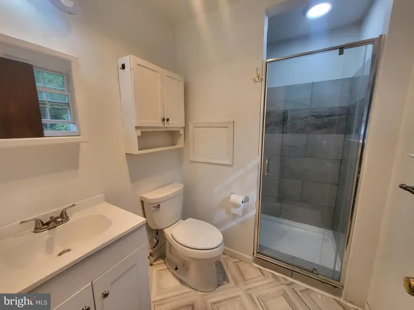 a bathroom with a toilet a sink and shower