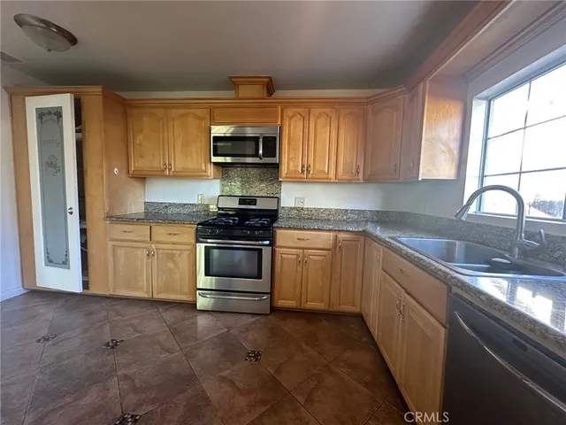a kitchen with stainless steel appliances a stove sink and cabinets