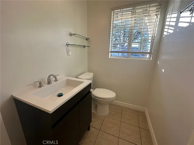 a bathroom with a sink mirror and toilet