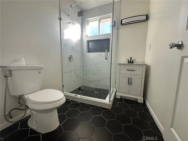 a bathroom with a toilet and a shower
