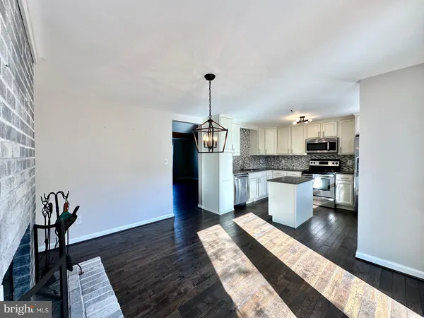 a open kitchen with stainless steel appliances granite countertop a stove a sink and a refrigerator