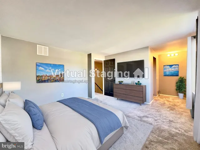 a bedroom with a large bed and a large mirror