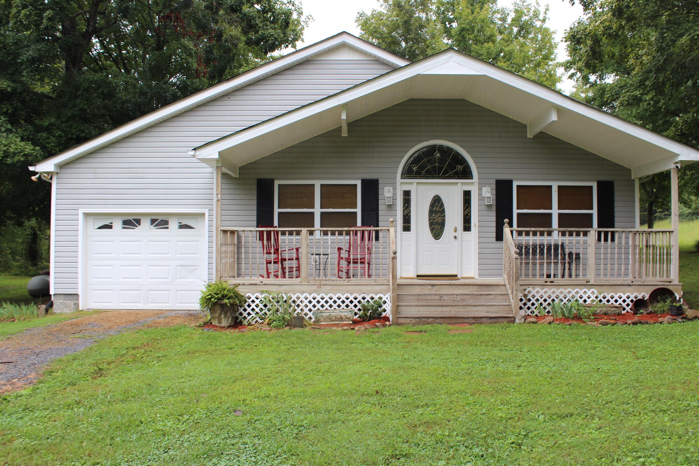 7052 Hall Road Greenbrier, TN 37073 - Photo 1 of 29 a front view of a house with a garden