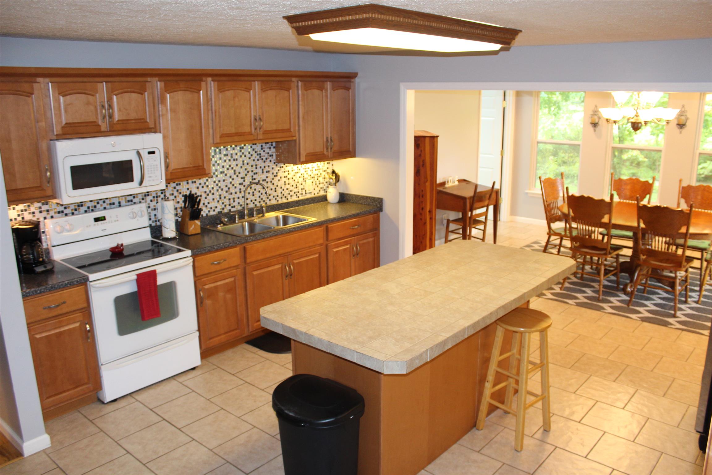 7052 Hall Road Greenbrier, TN 37073 - Photo 11 of 29 a kitchen with stainless steel appliances granite countertop a stove a sink and a microwave
