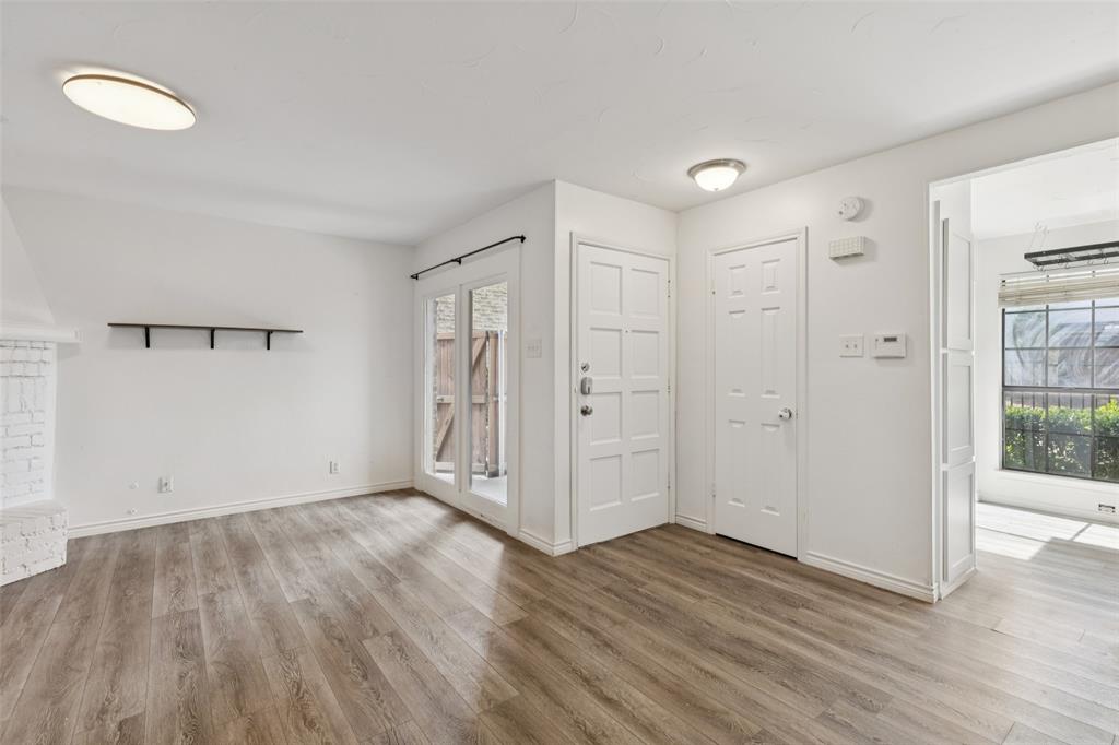 5200 Martel Avenue, Unit 36A Dallas, TX 75206 - Photo 14 of 34 a view of an empty room with wooden floor and a window
