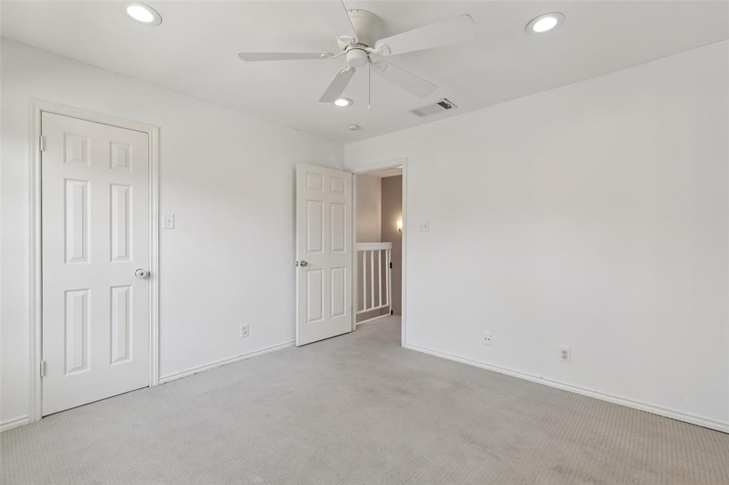5200 Martel Avenue, Unit 36A Dallas, TX 75206 - Photo 20 of 34 an empty room with fan and a ceiling fan