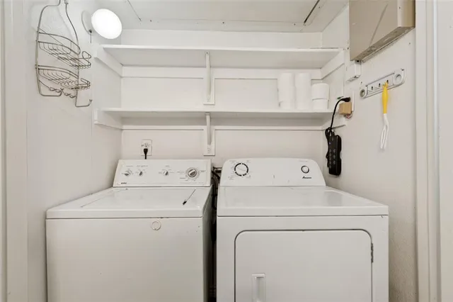 a view of storage and utility room with washer and dryer